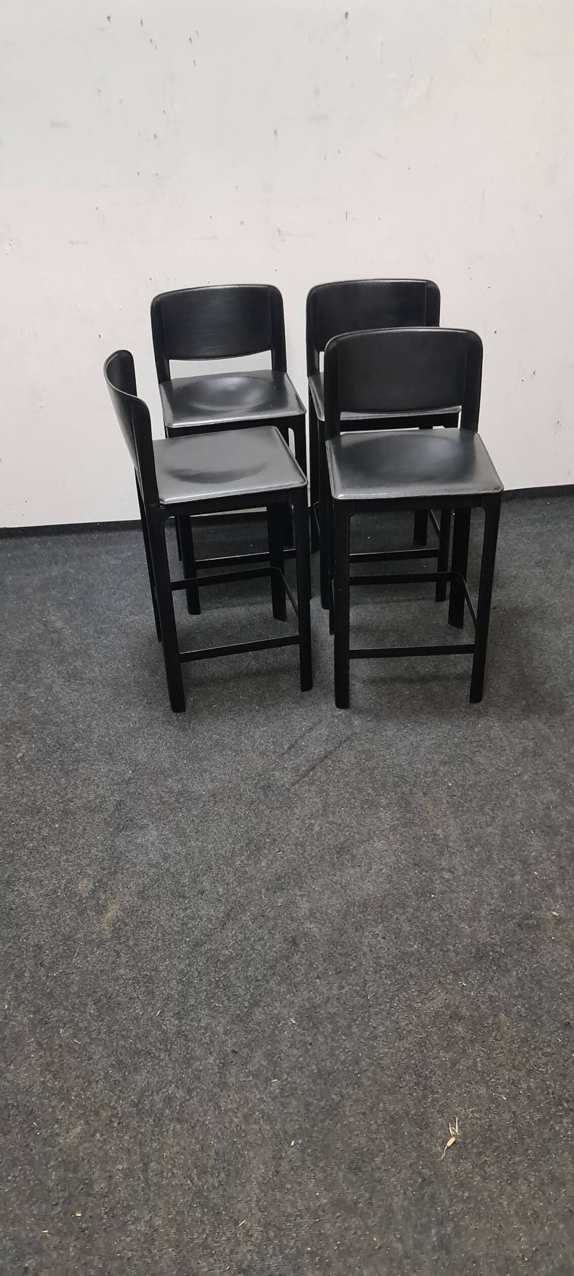 A set of four Italian leather bar stools by Matteo Grassi