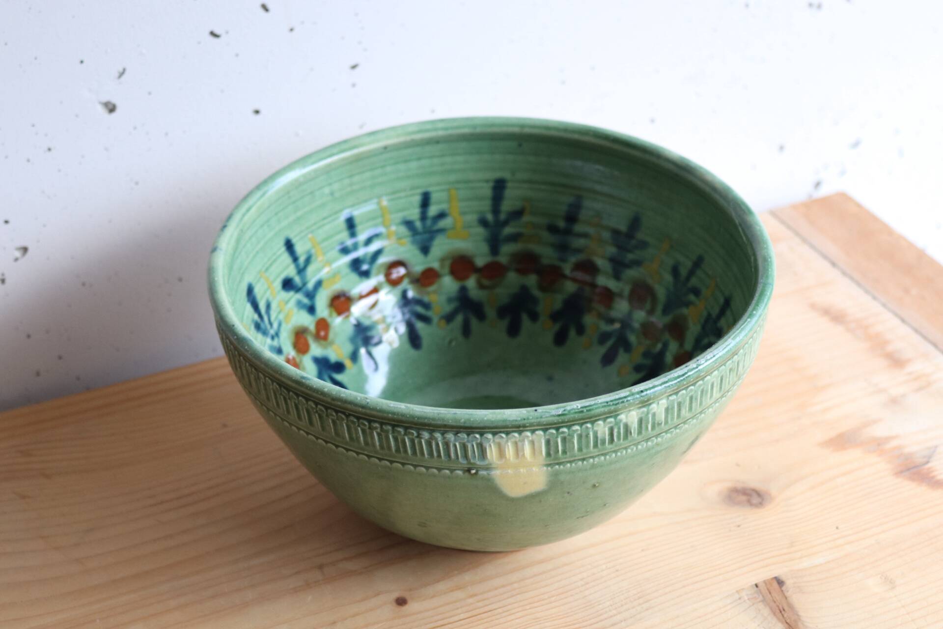 Large glazed ceramic salad bowl with a floral design.
