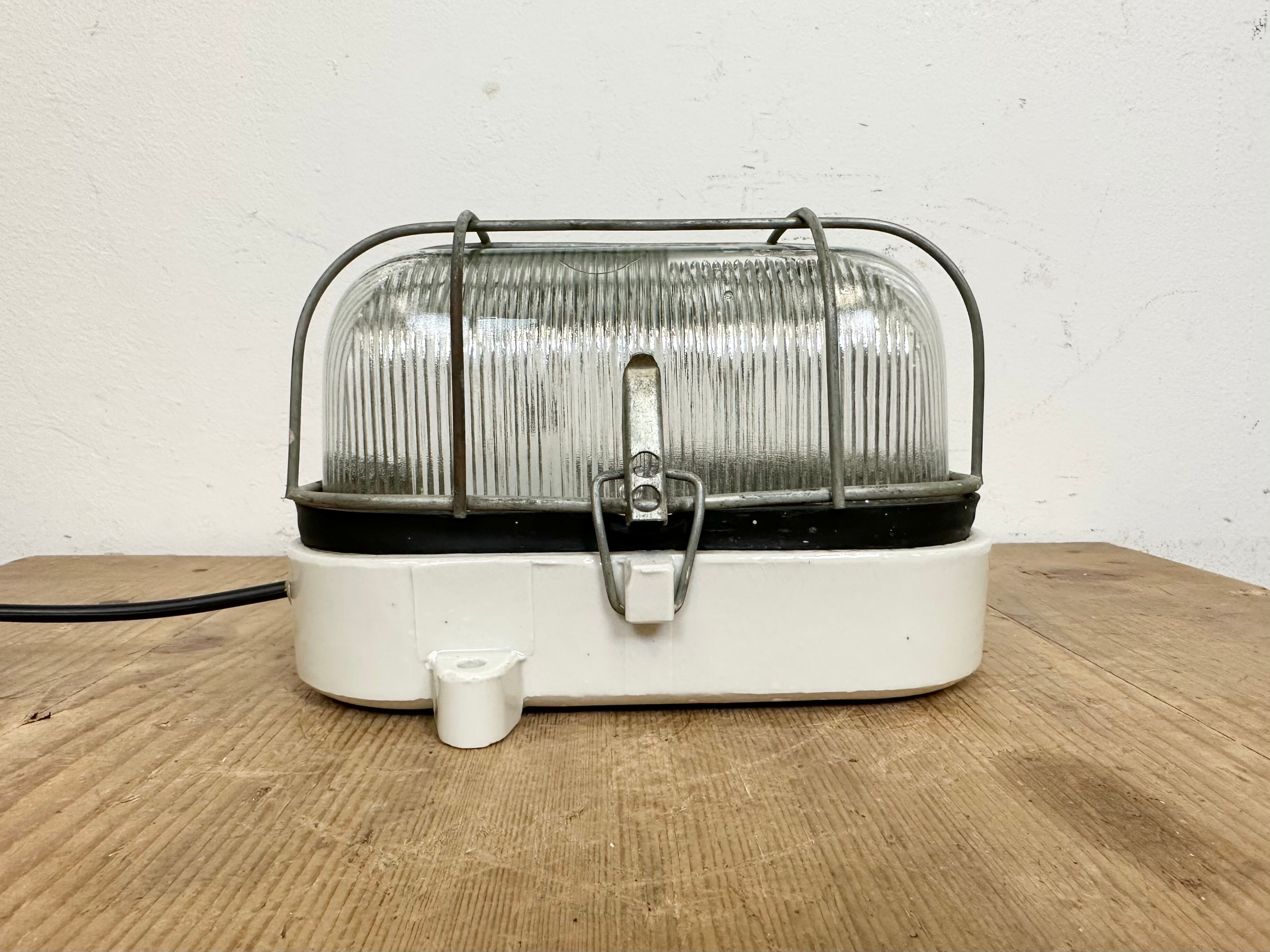 Industrial white porcelain cage wall light with ribbed glass, 1970s