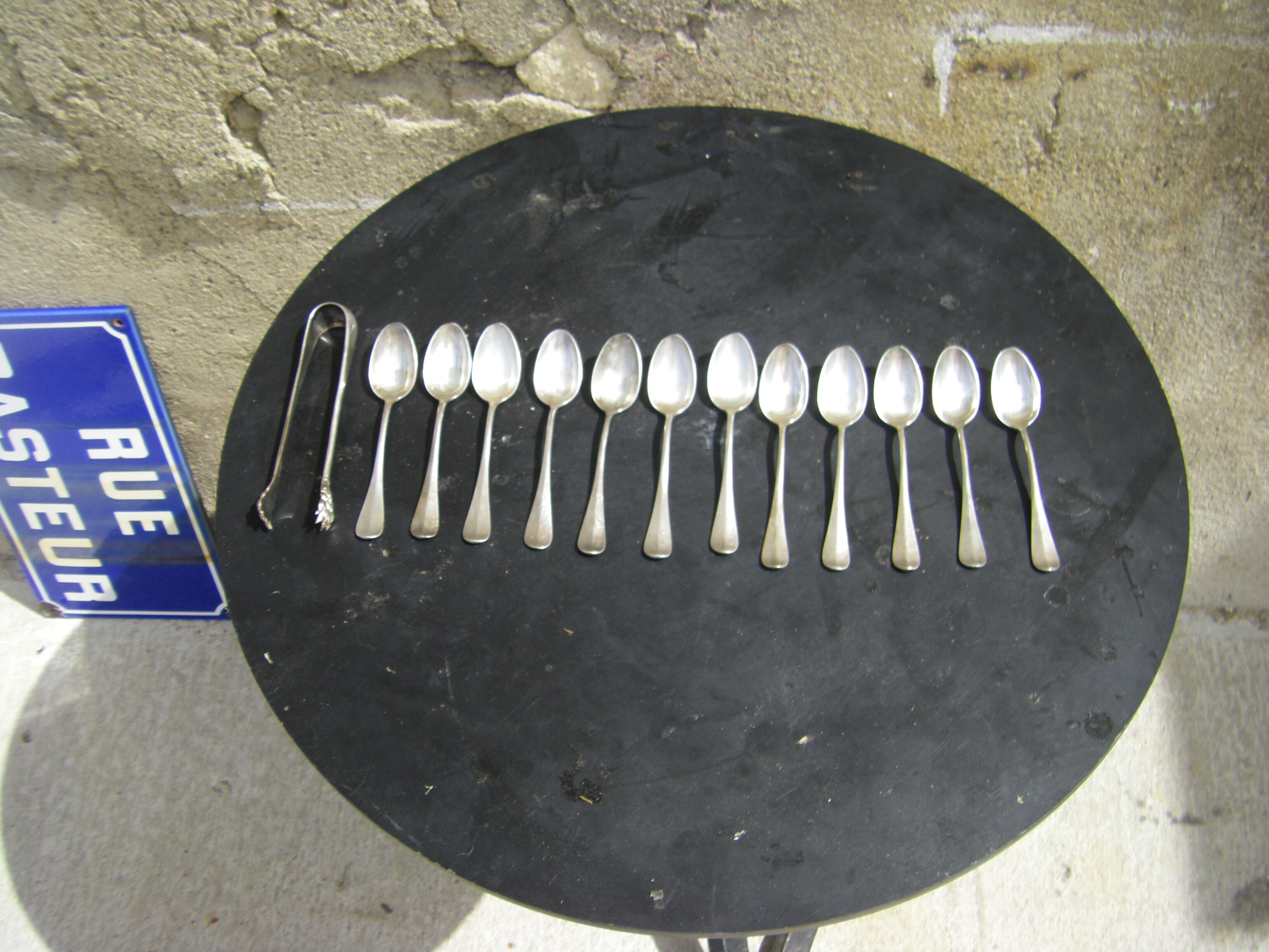 Set of twelve teaspoons and a sugar tongs