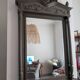 Antique carved mirror with a grey-green patina, Louis XVI style.