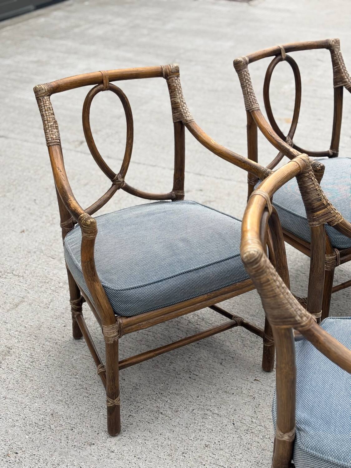 Set of 4 vintage McGuire rattan chairs with cushions.