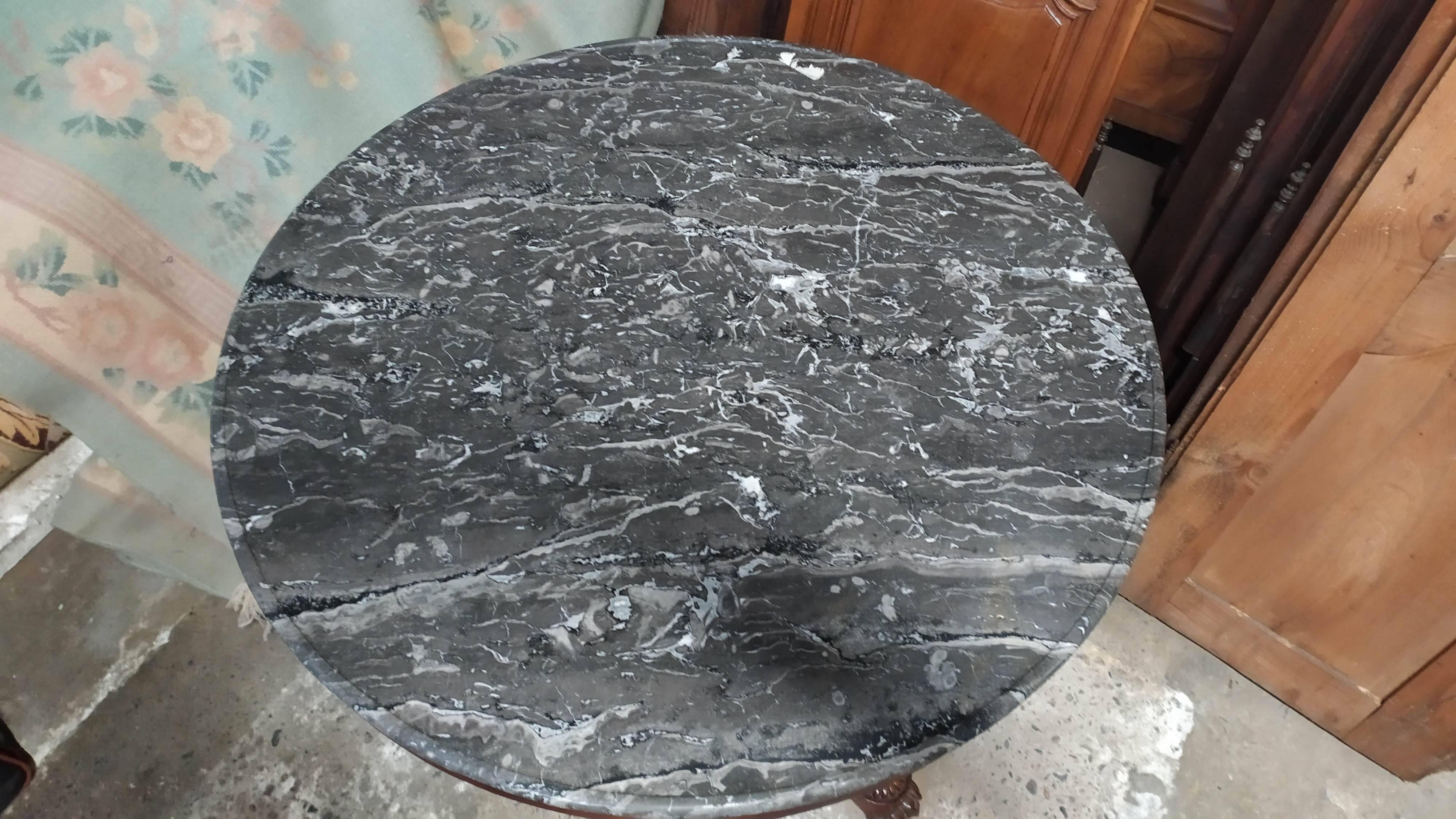Pedestal table with gray depression marble
