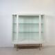 White vintage slatted display case on gold legs