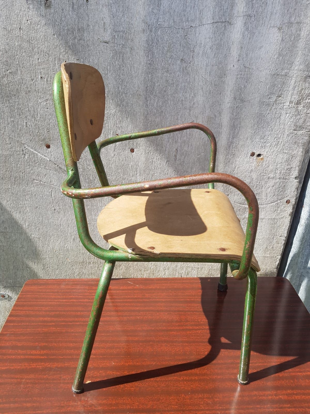 Former green metal child chair