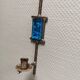 Wall-mounted candle holder in cast iron and hard pressed blue glass.