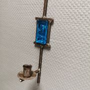Wall-mounted candle holder in cast iron and hard pressed blue glass.