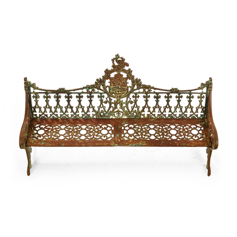 Sculpted cast iron bench with green patina