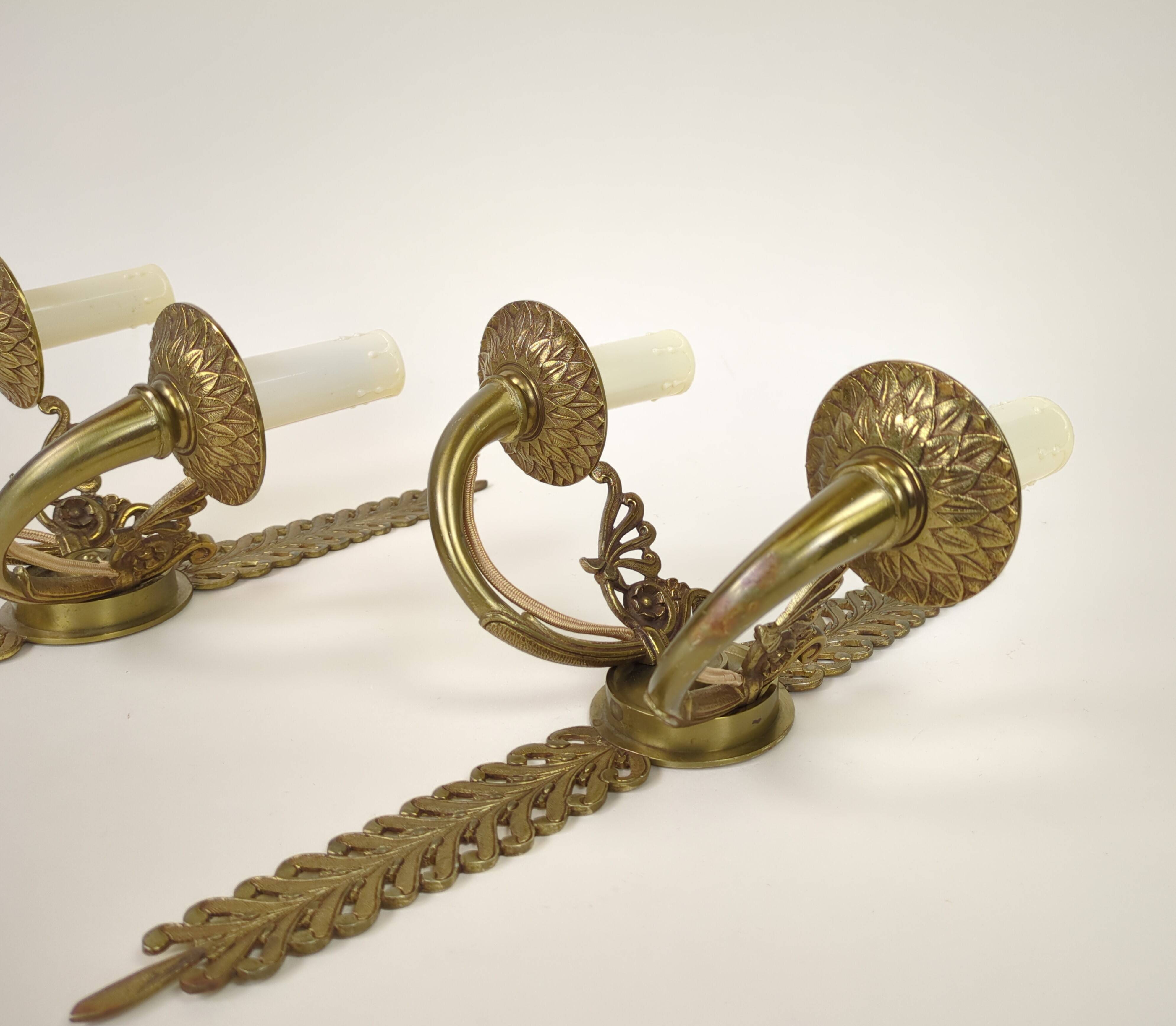 Pair of two-armed Empire wall sconces in gilded bronze