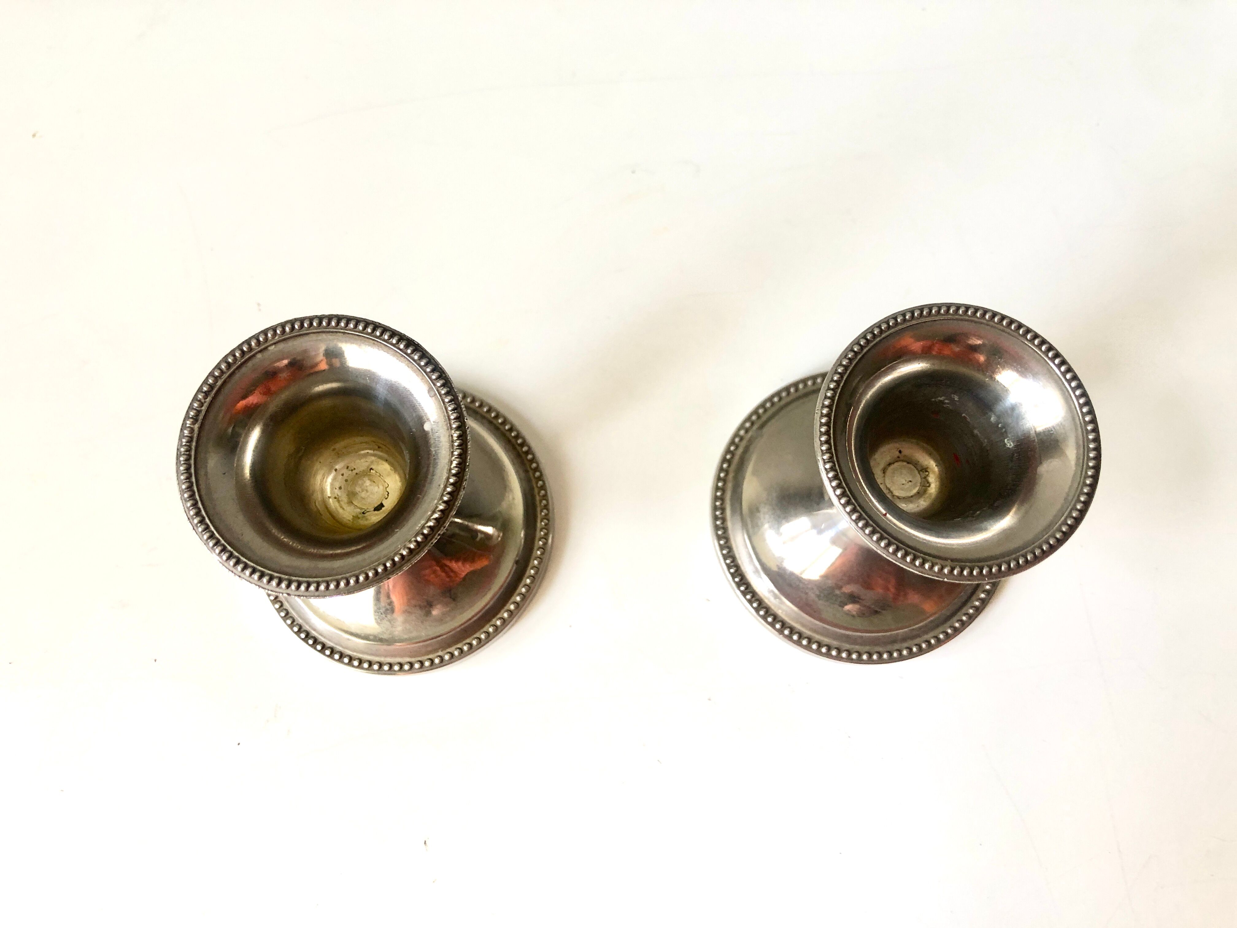 Pair of silver metal candle holders