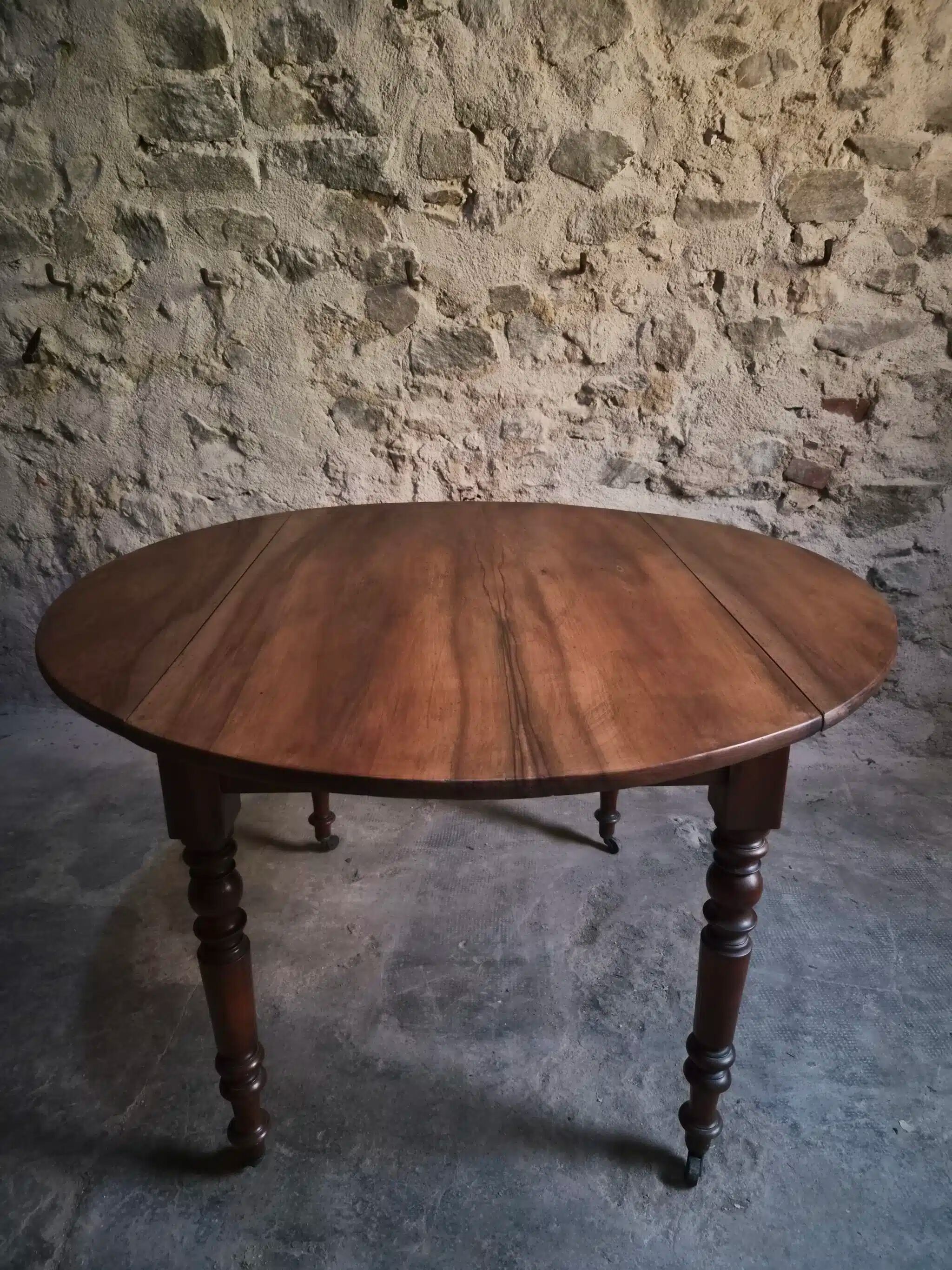 Antique drop-leaf dining table in walnut, France, circa 1900.