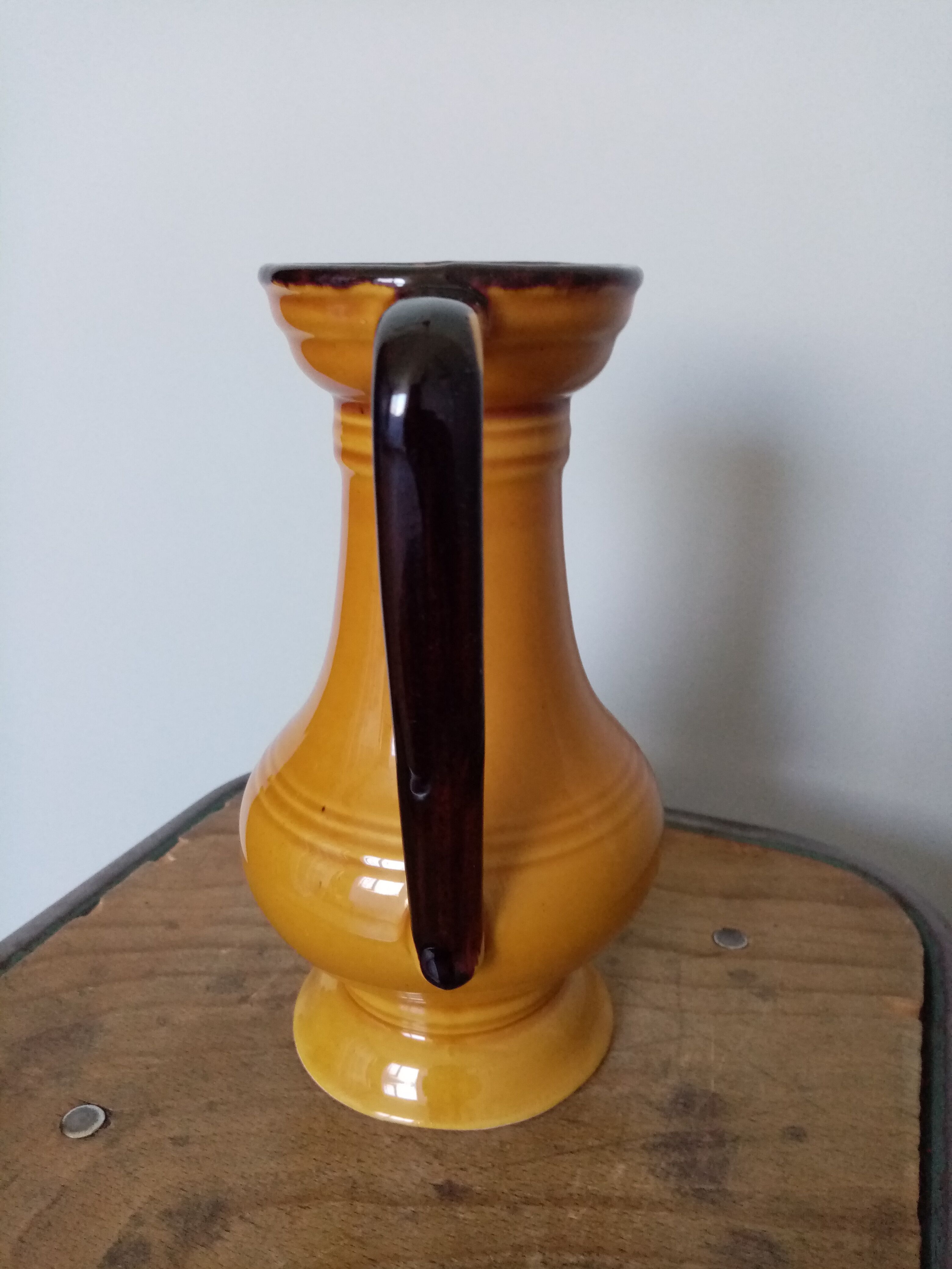 Mustard yellow enamelled ceramic pitcher