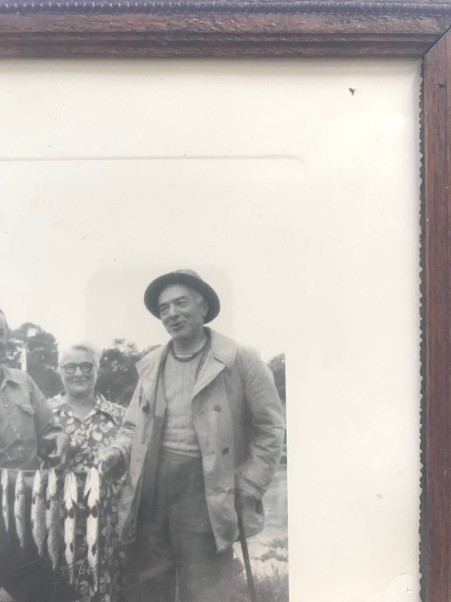 Fishing trophy with radiant faces, c. 1950. Black and white photograph.