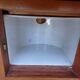 Antique bedside table with its marble top and white earthenware interior