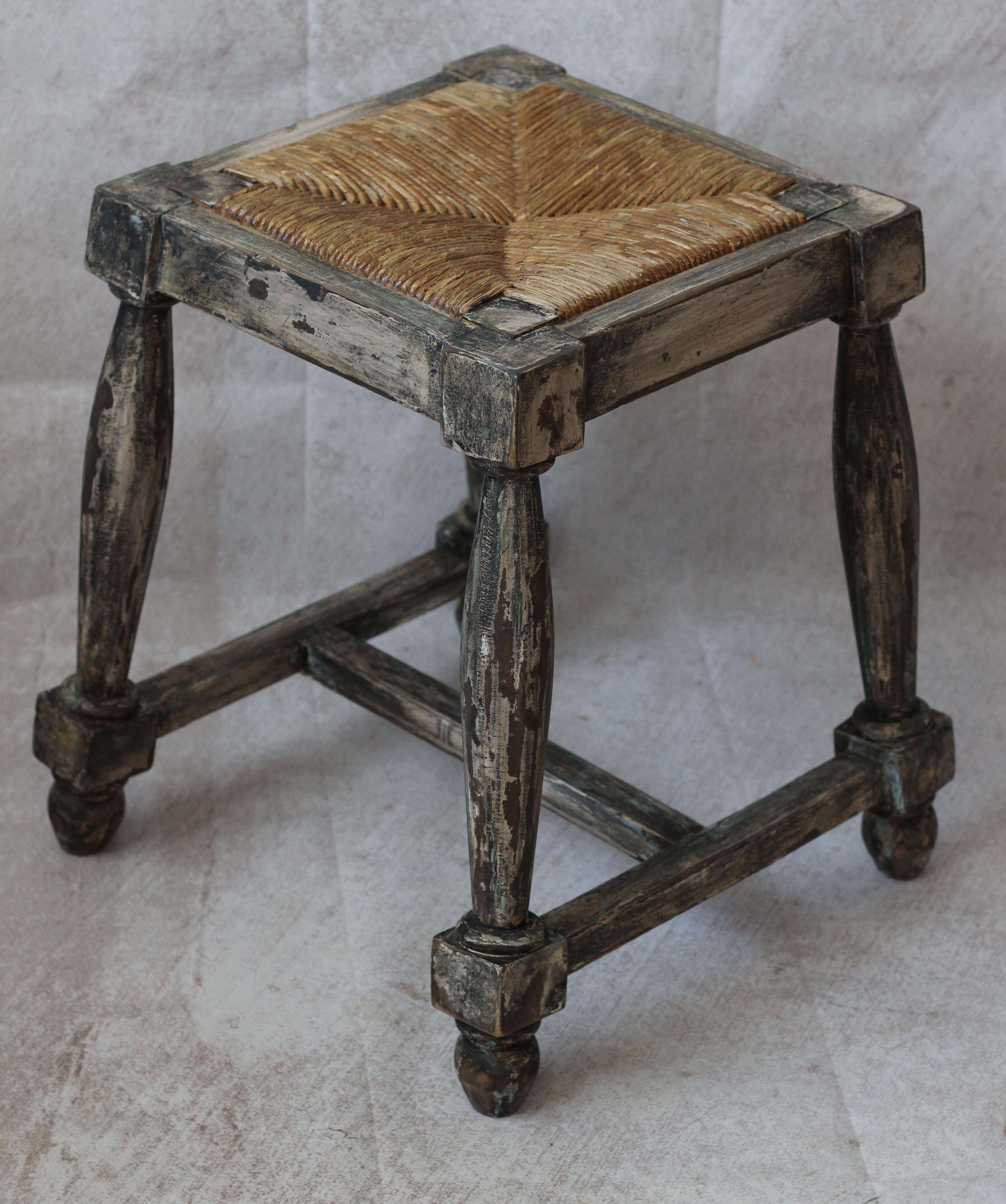 Patinated wooden stool with straw seat