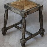 Patinated wooden stool with straw seat
