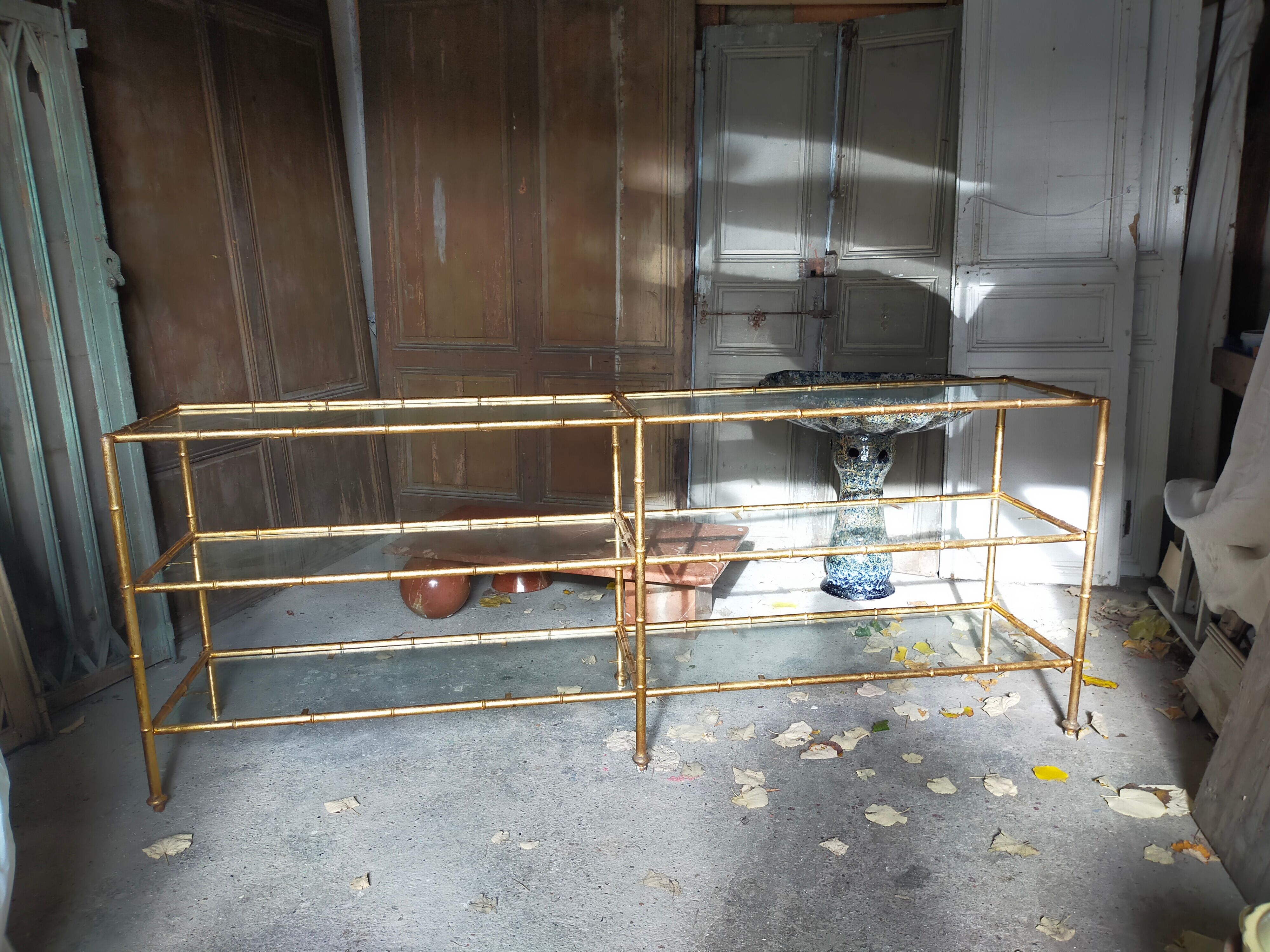 Console in gilded metal and glass