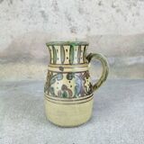 Glazed earthenware pitcher signed Riou.
