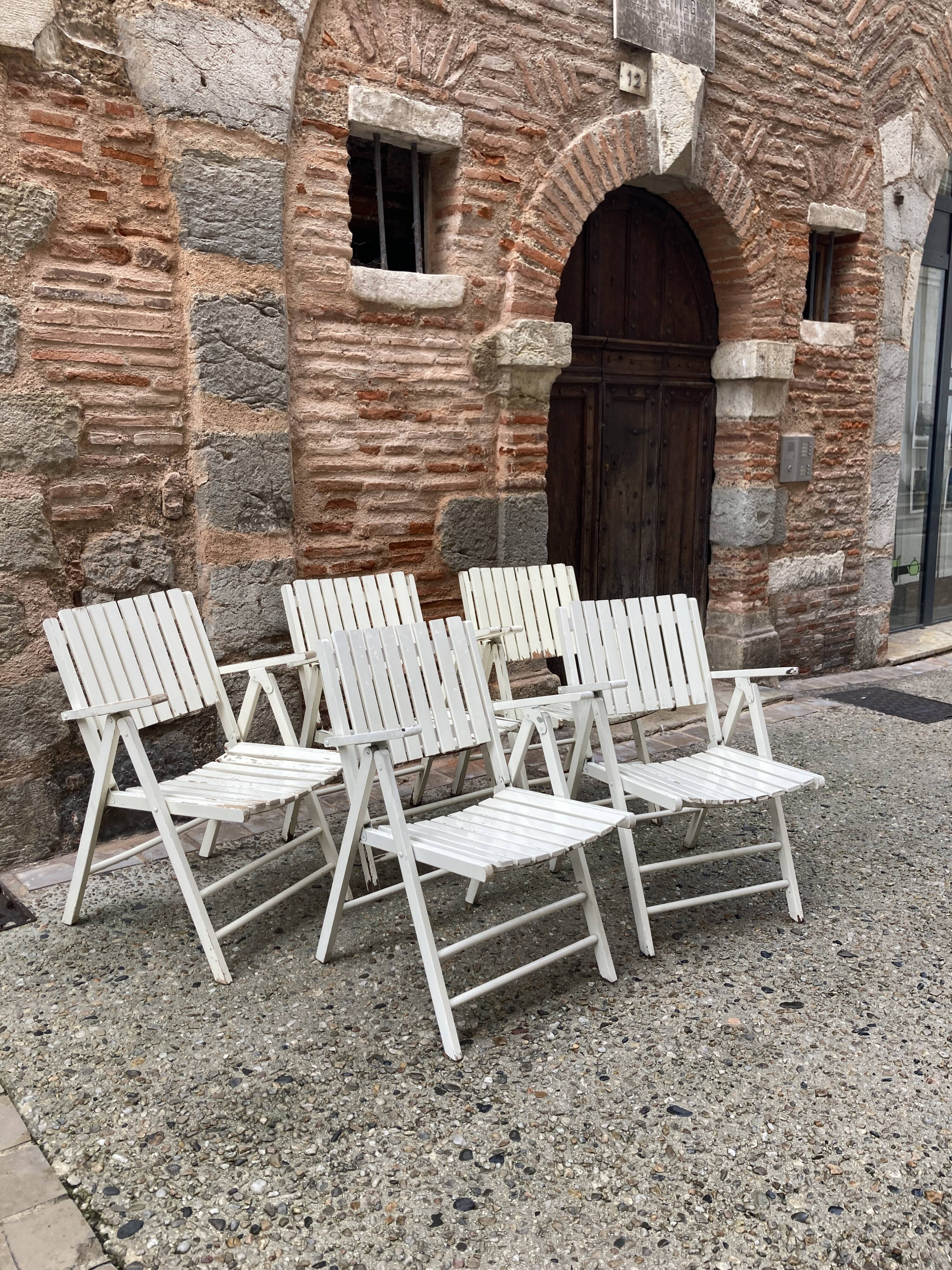 Five wooden garden armchairs