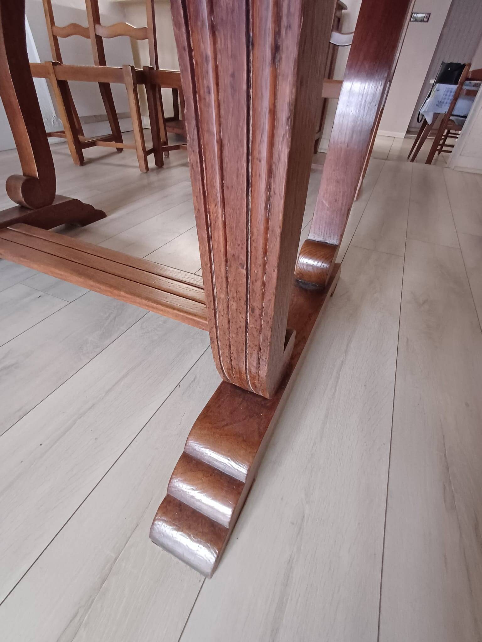 Solid wood dining table with a sculptural base.