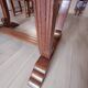 Solid wood dining table with a sculptural base.