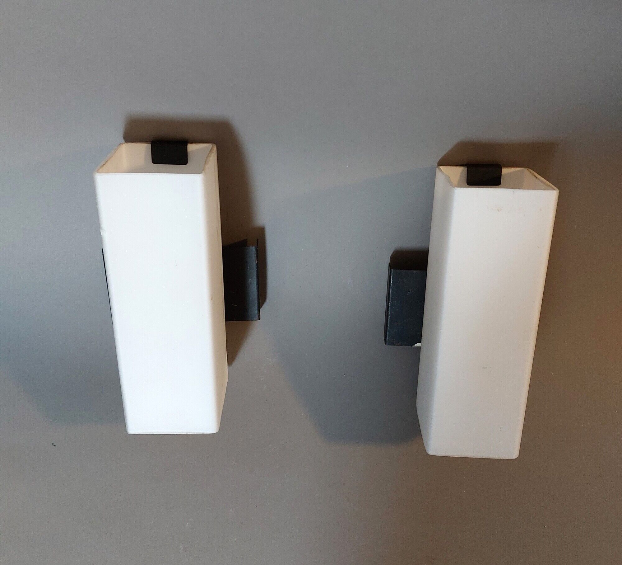 Pair of modernist sconces in black metal and white opaline vintage