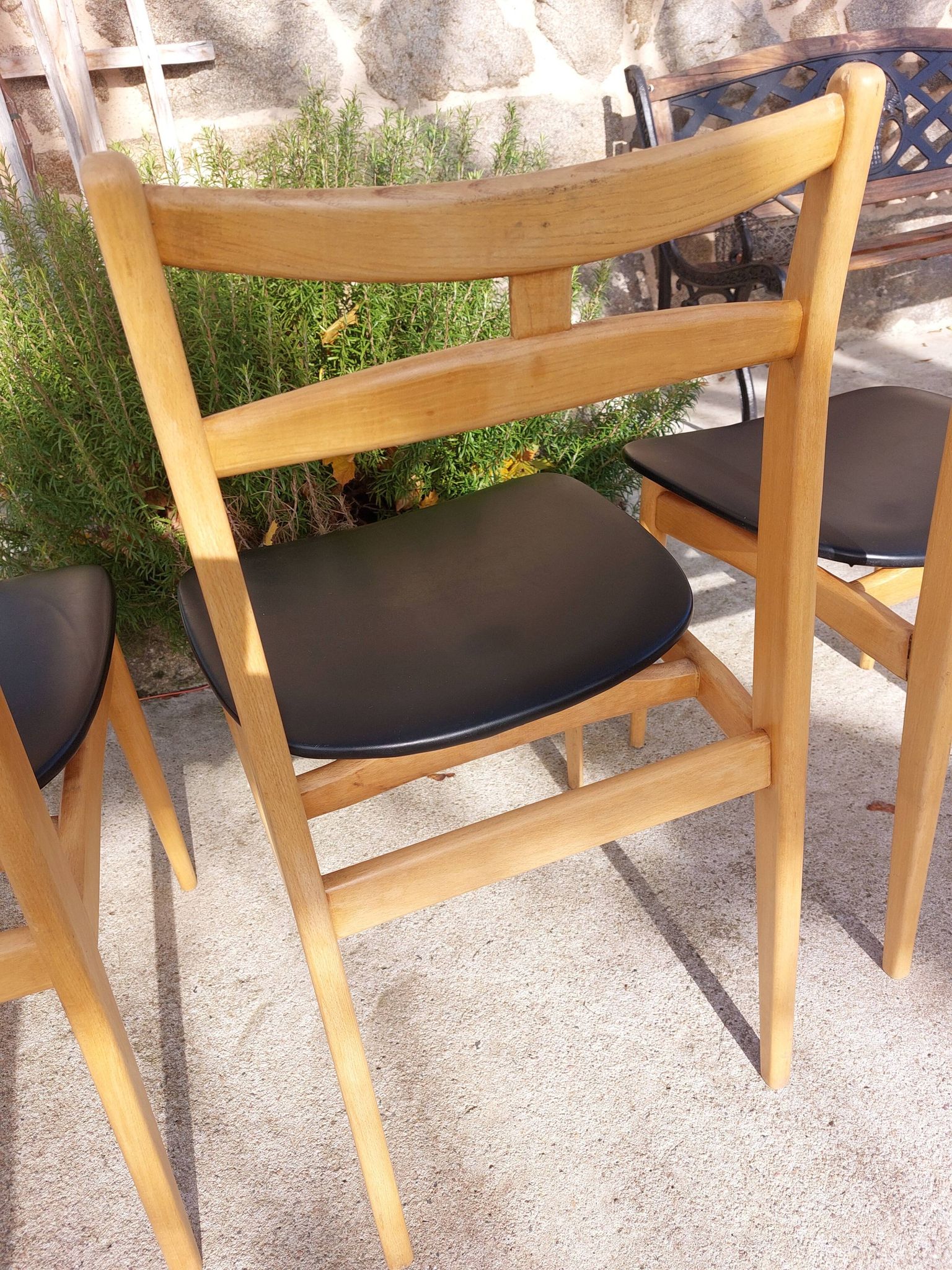 3 Scandinavian style chairs, light wood and black faux leather.