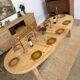 Oval farmhouse table in solid oak with extensions.