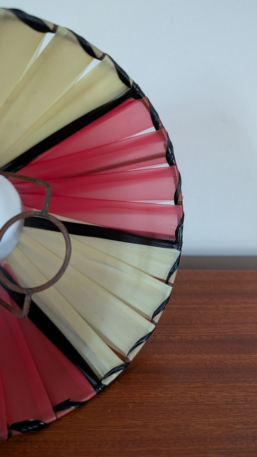 Pleated red and pale yellow plastic conical lampshade from the 1960s.