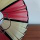Pleated red and pale yellow plastic conical lampshade from the 1960s.