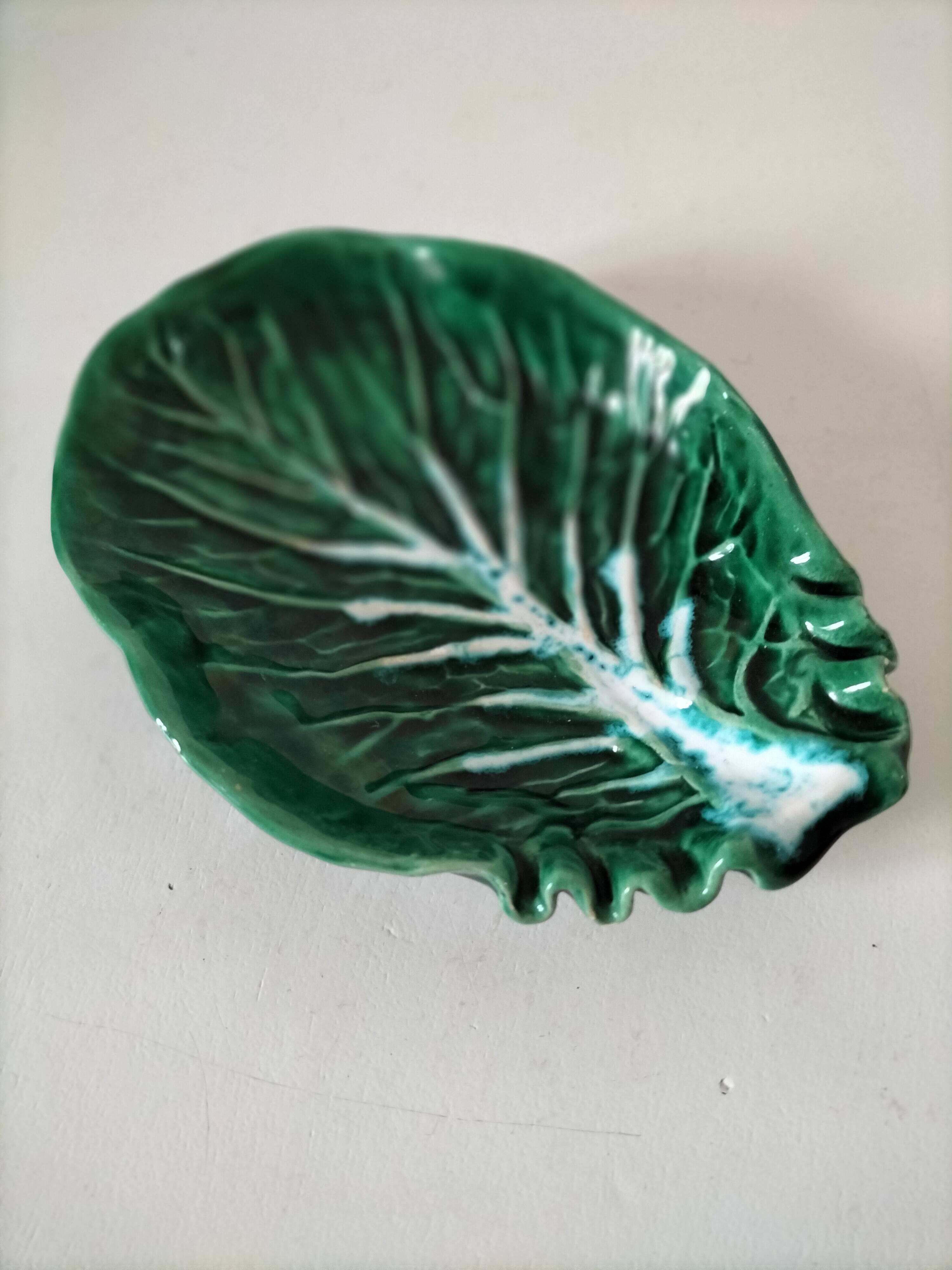Vintage green slipware bowl in the shape of a cabbage leaf.