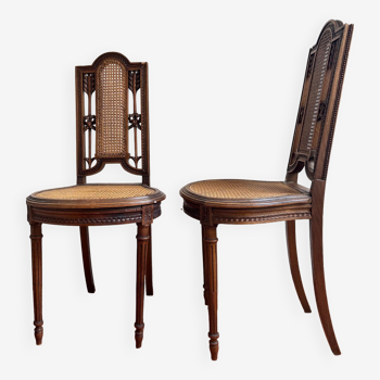 Pair of Louis XVI caned chairs carved gilded wood arrows knots late 19th century