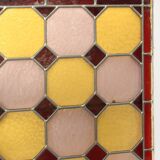Old stained glass window with geometric patterns