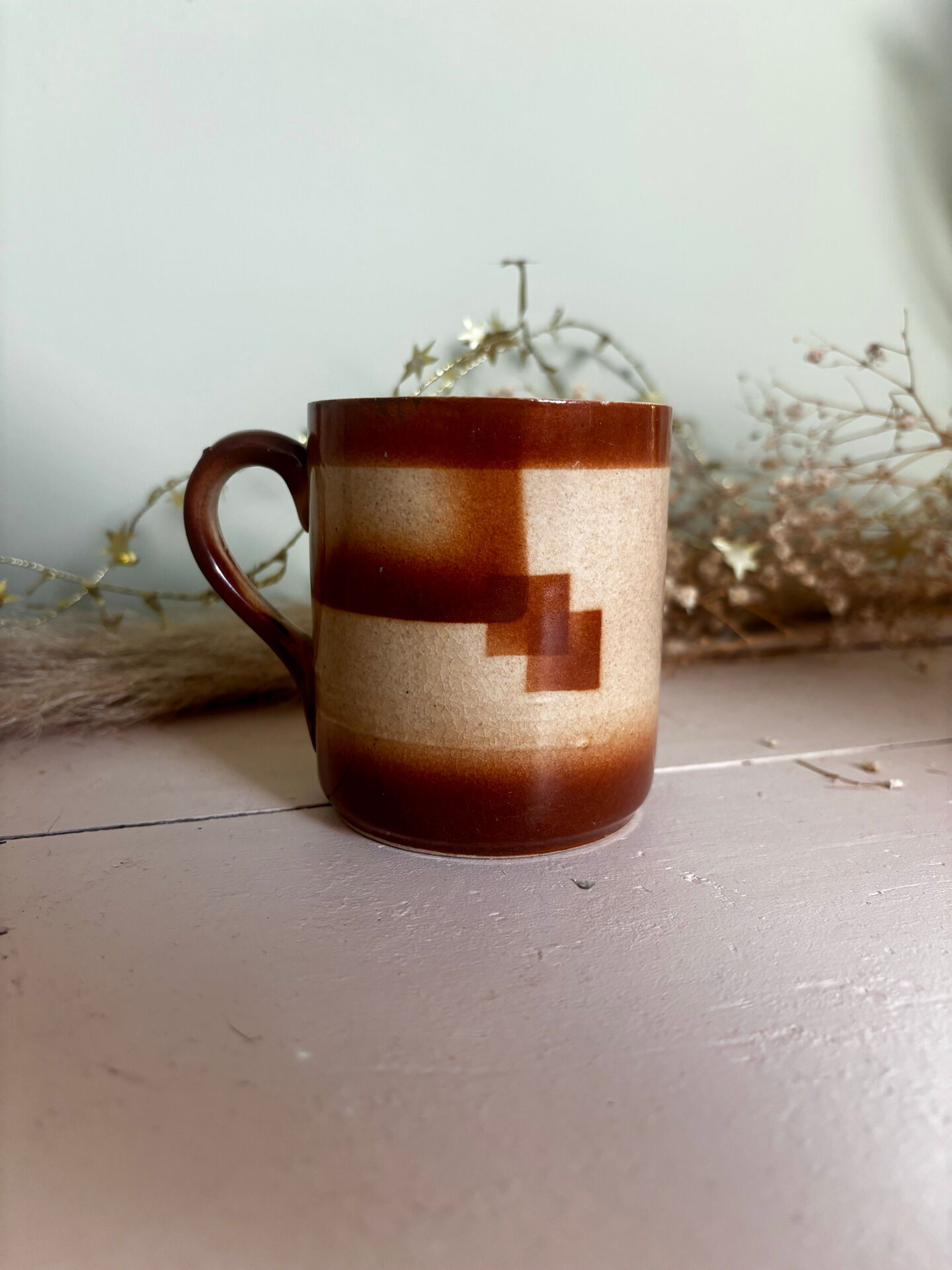 Vintage 70s old ceramic mug with a brown cubic graphic pattern.