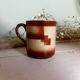 Vintage 70s old ceramic mug with a brown cubic graphic pattern.