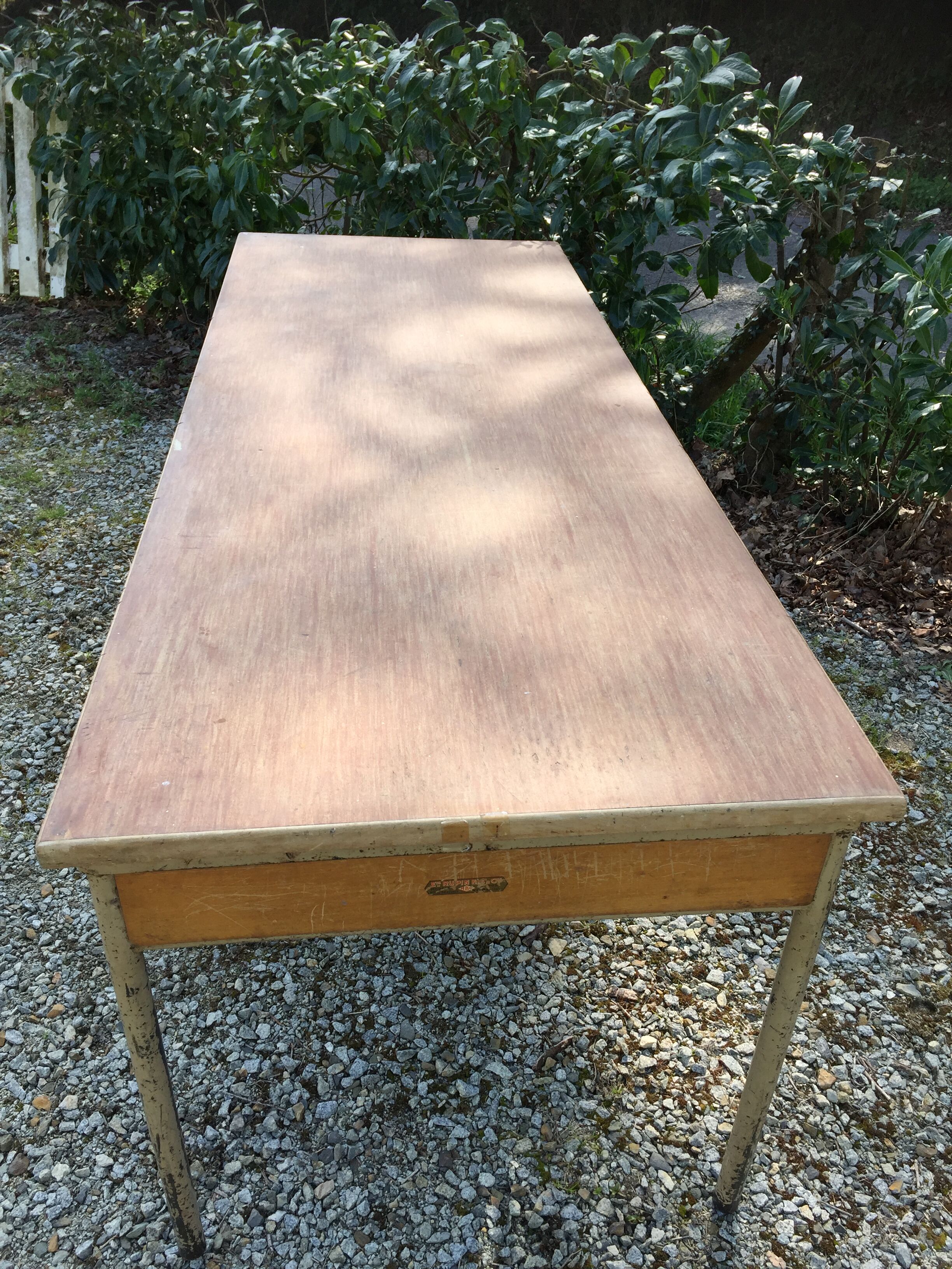 Vintage modernist table with metal tubular base and top covered with oilcloth.
