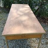 Vintage modernist table with metal tubular base and top covered with oilcloth.