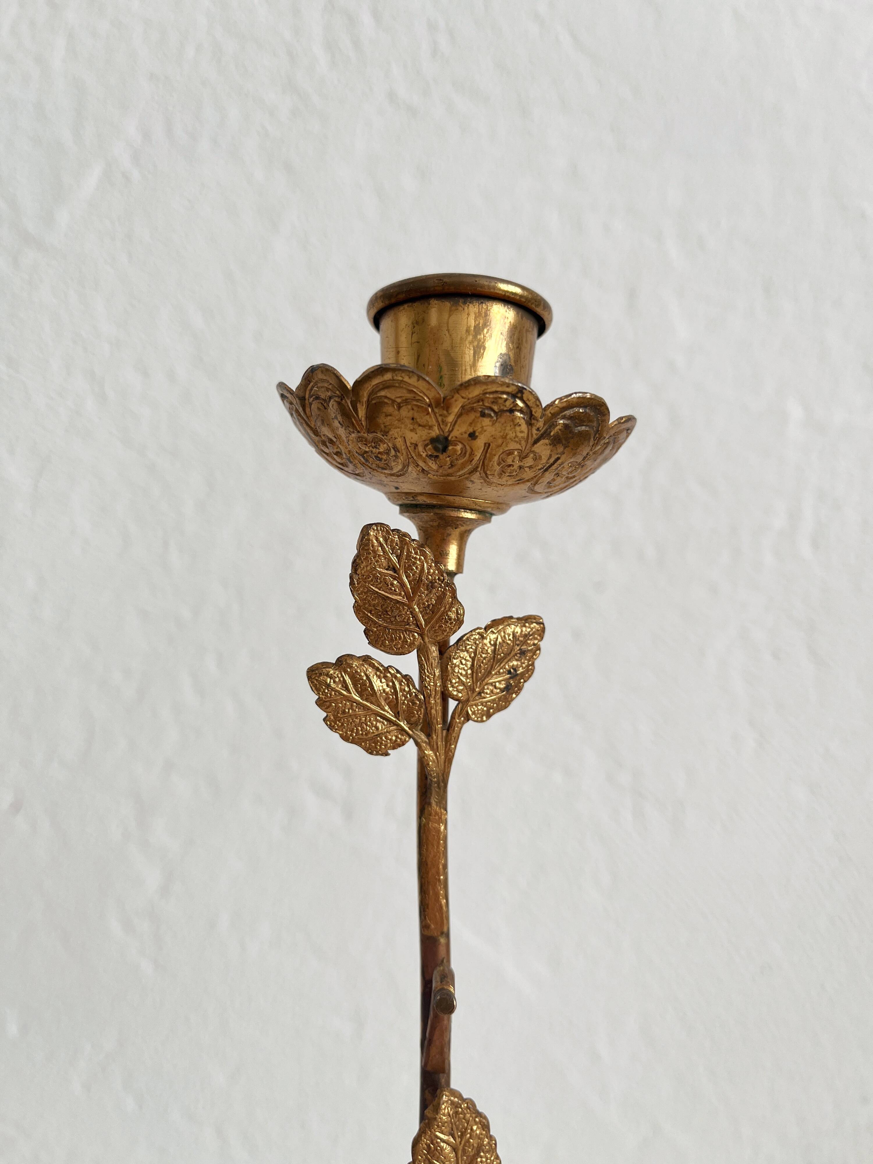Antique bronze and brass candlestick with golden leaves