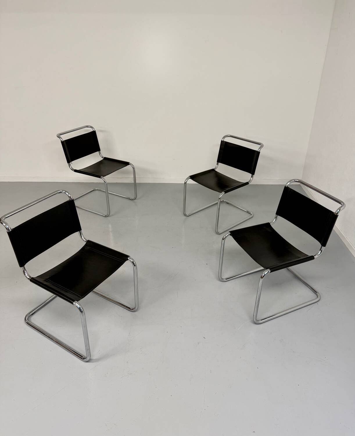 Lot of 4 tubular chairs designed by Mart Stam in vintage black leather from the 1980s.
