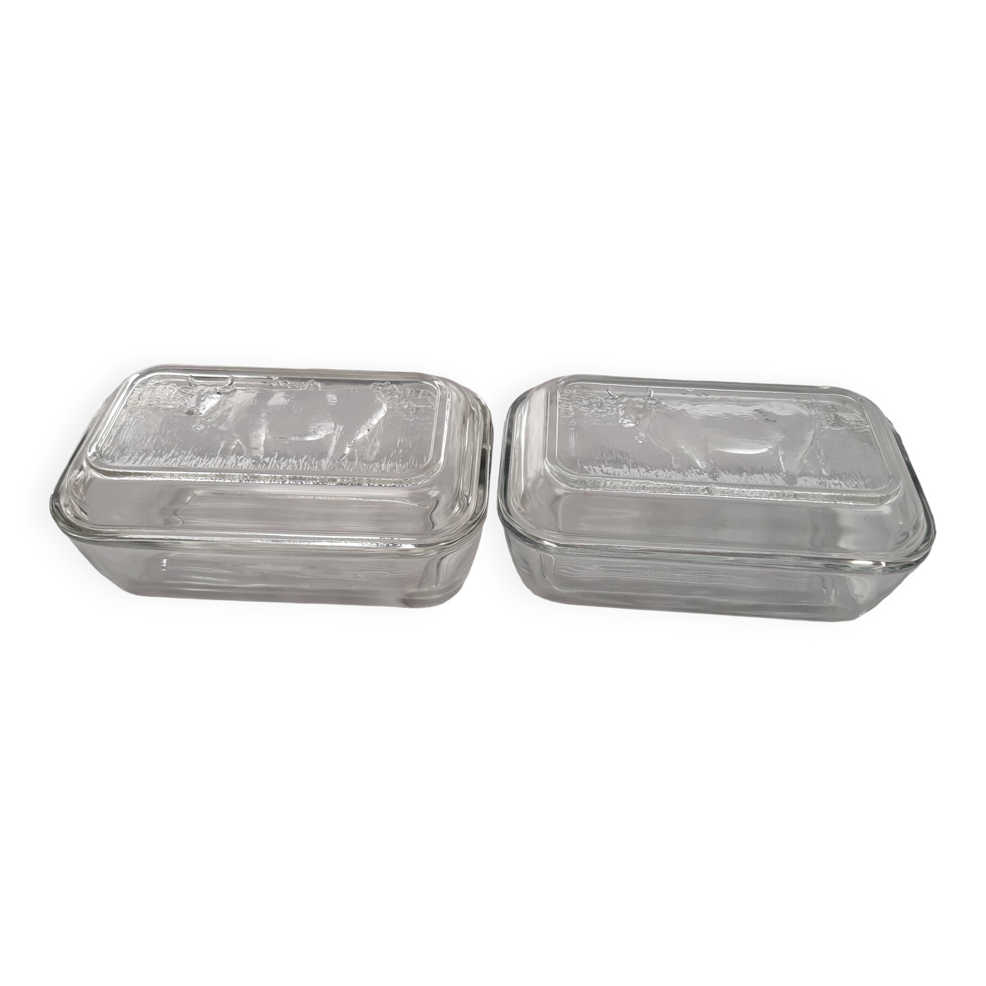 Two Arcoroc glass dairy cow butter dishes