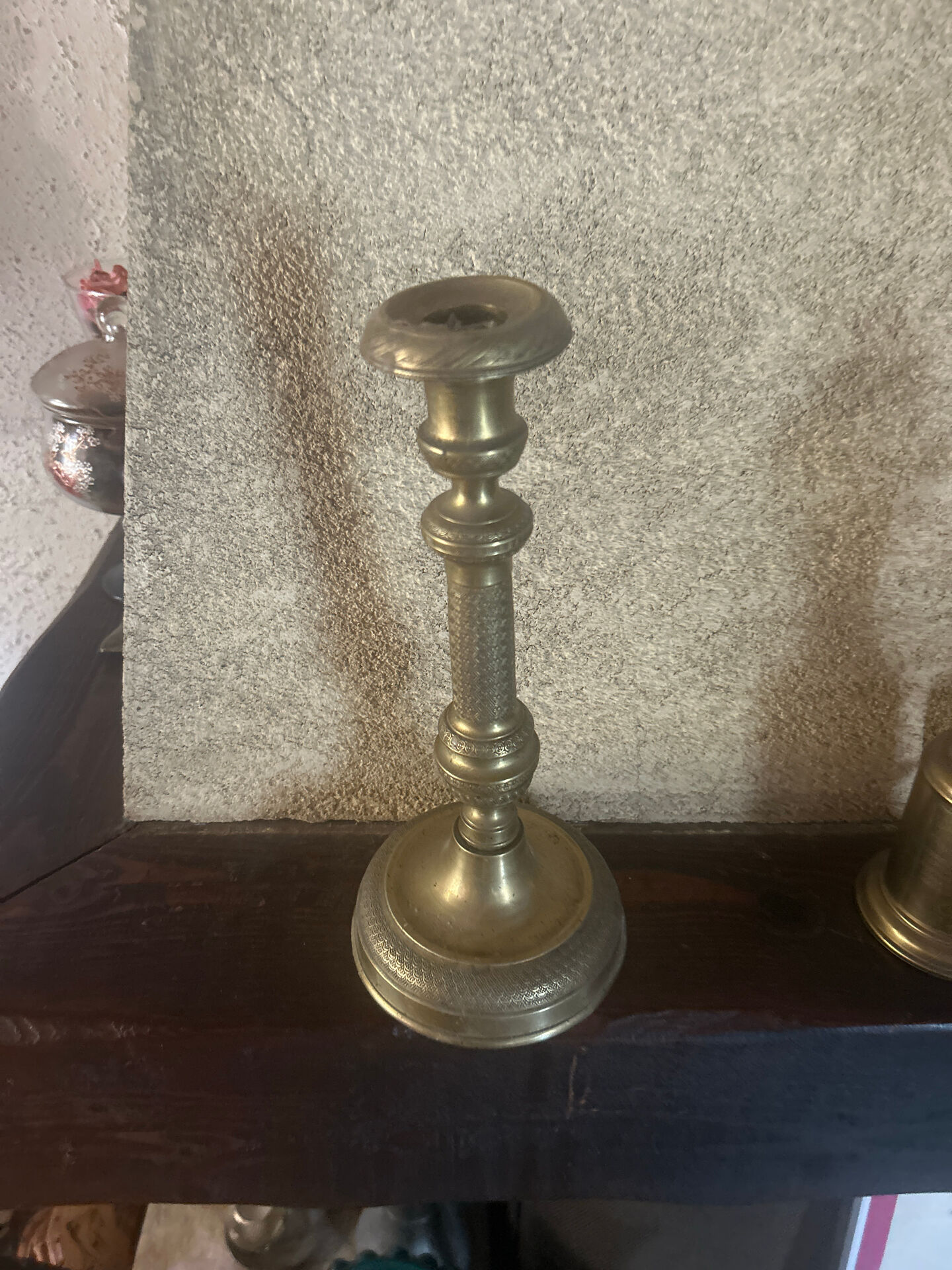 Large antique brass candlestick with floral decoration.