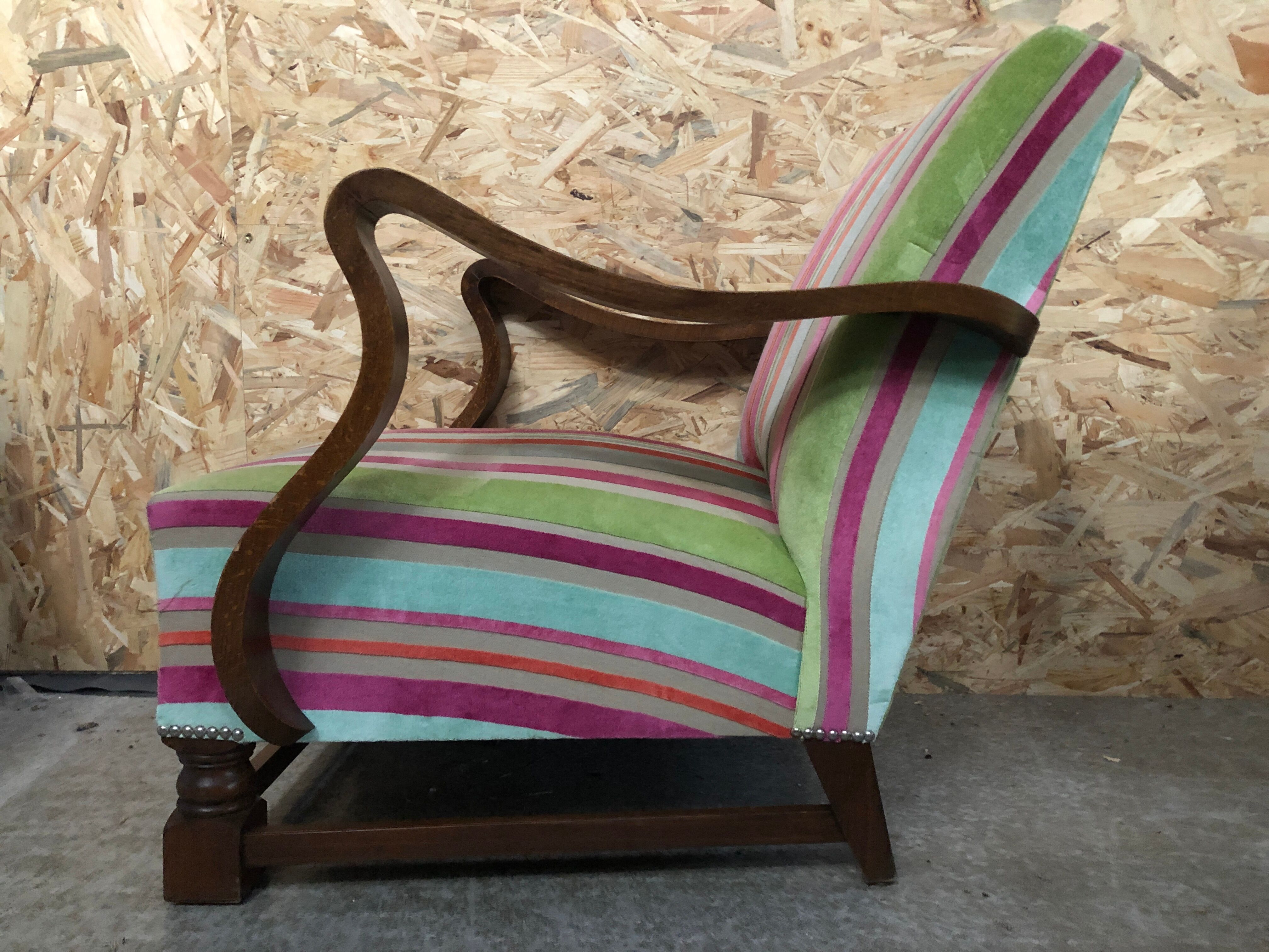 Old wooden armchair with curved armrests