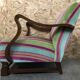 Old wooden armchair with curved armrests