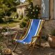 Vintage deck chair with blue and yellow striped fabric, original patina.