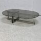 Coffee table with steel base and smoked glass slab. Circa 197
