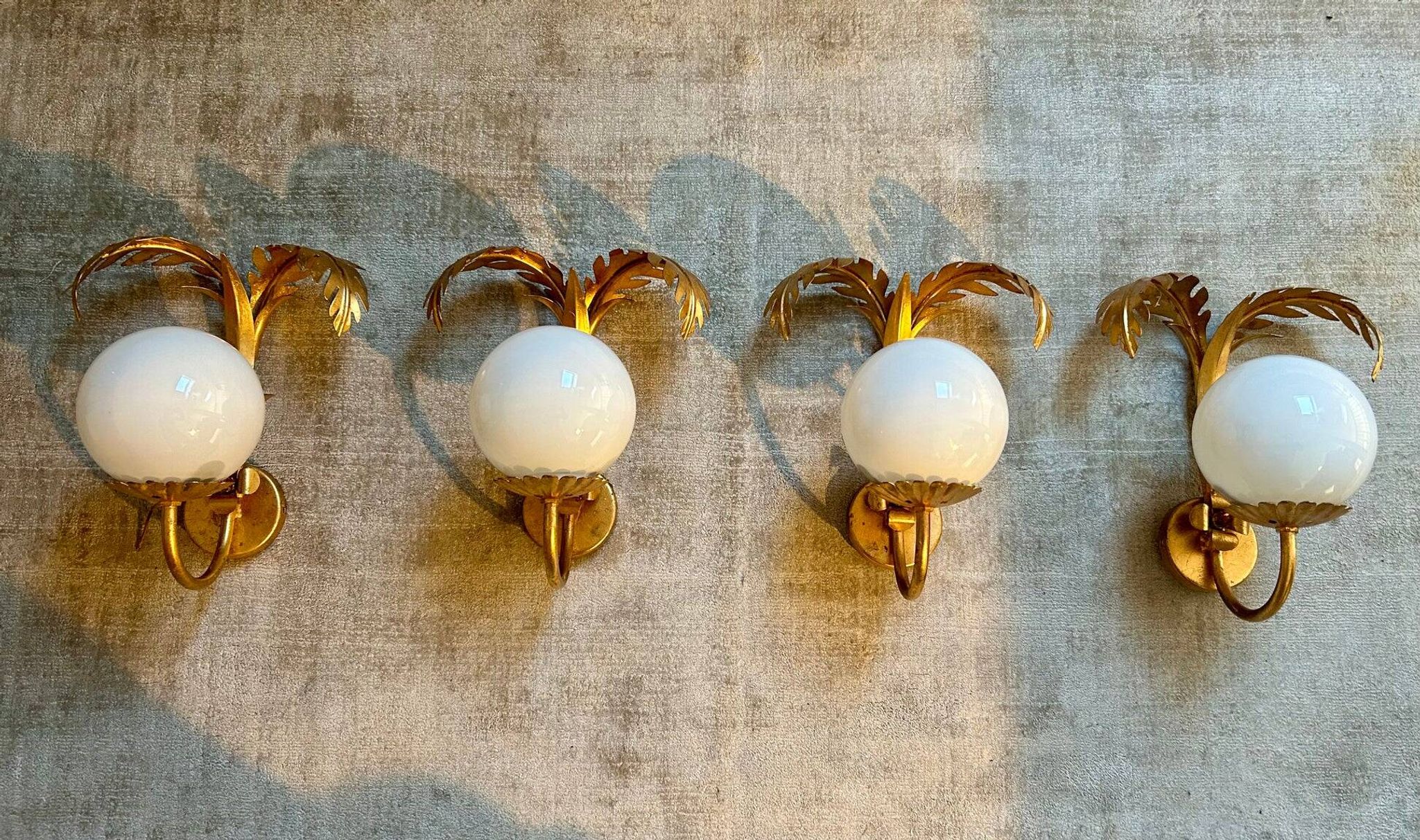 Pair of palm leaf wall lights in Hollywood Regency style with opaque globes by Hans Kögl, Germany, 1970s.