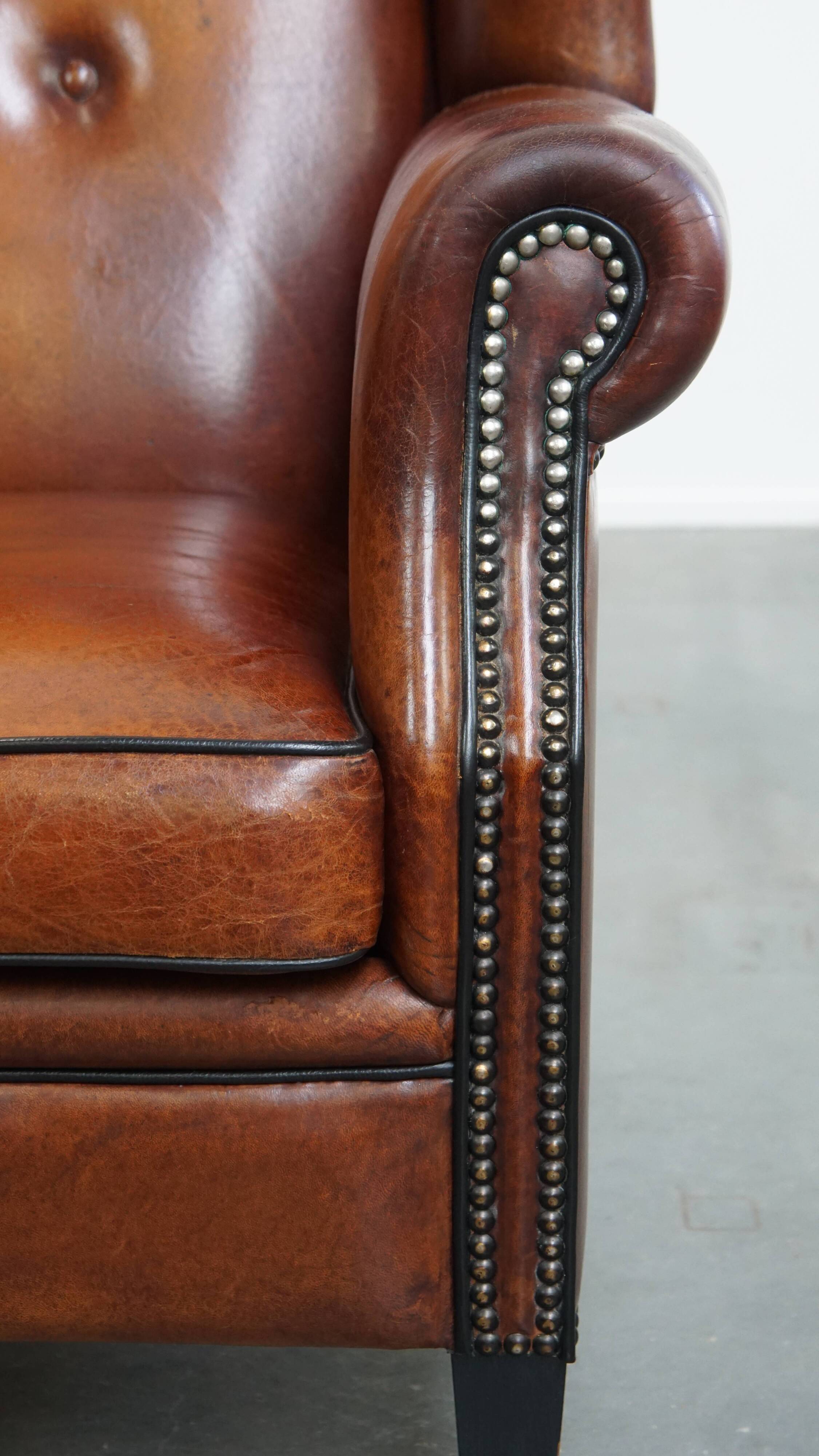 Sheepskin Wingback Chair with Warm Tones and Black Piping