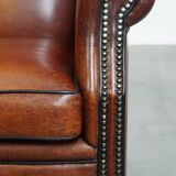 Sheepskin Wingback Chair with Warm Tones and Black Piping