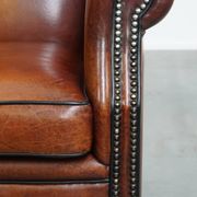 Sheepskin Wingback Chair with Warm Tones and Black Piping