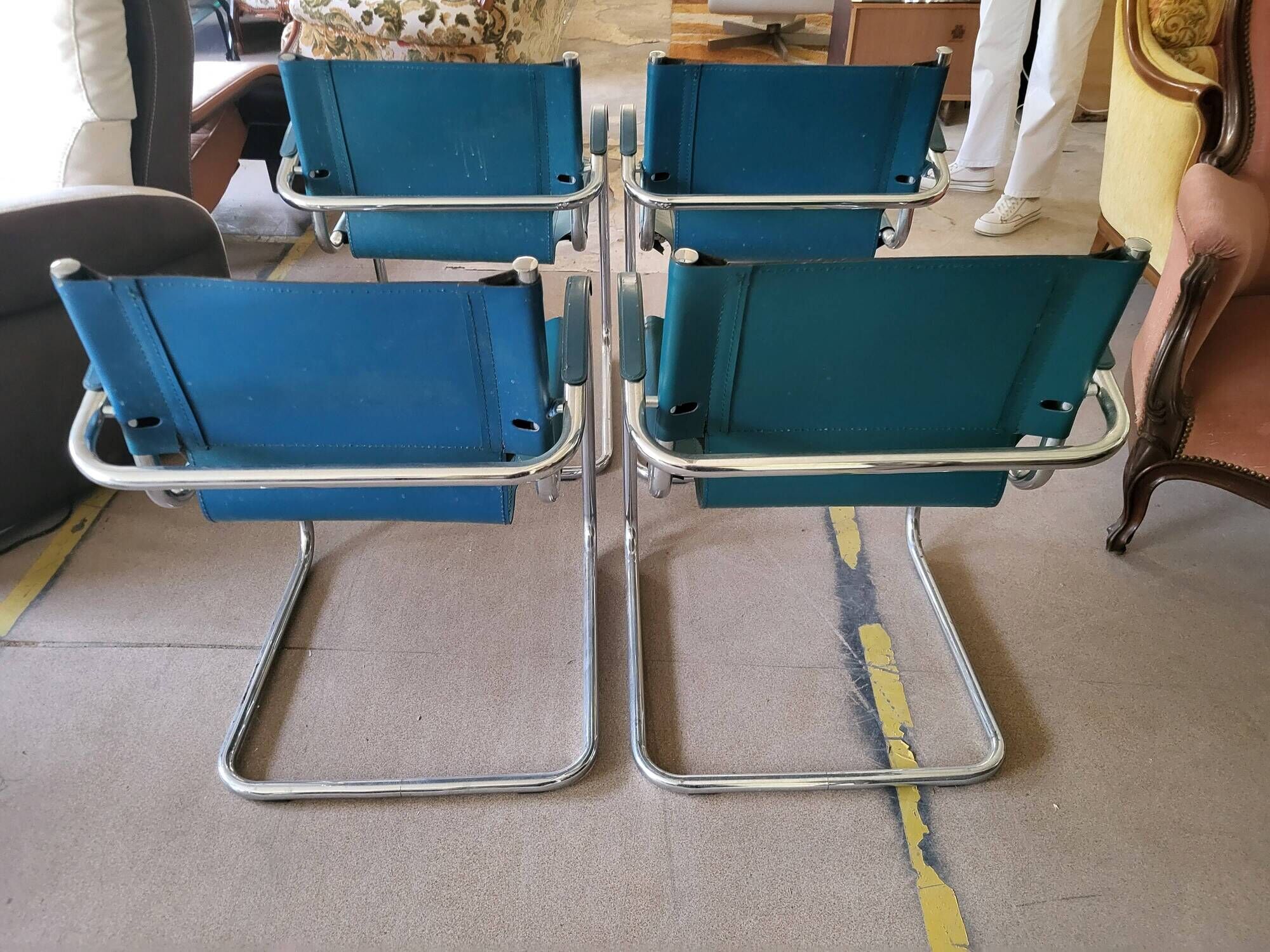 4 vintage Italian armchairs in green leather and chrome metal.